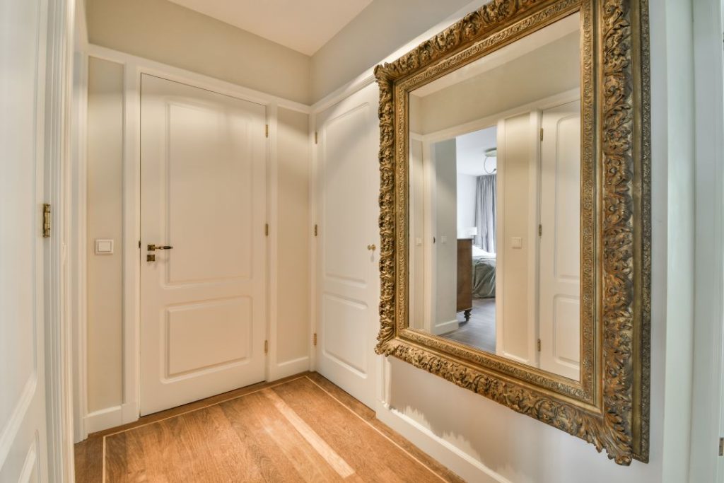 Large corridor mirror reflecting light and creating space