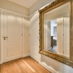 Large corridor mirror reflecting light and creating space